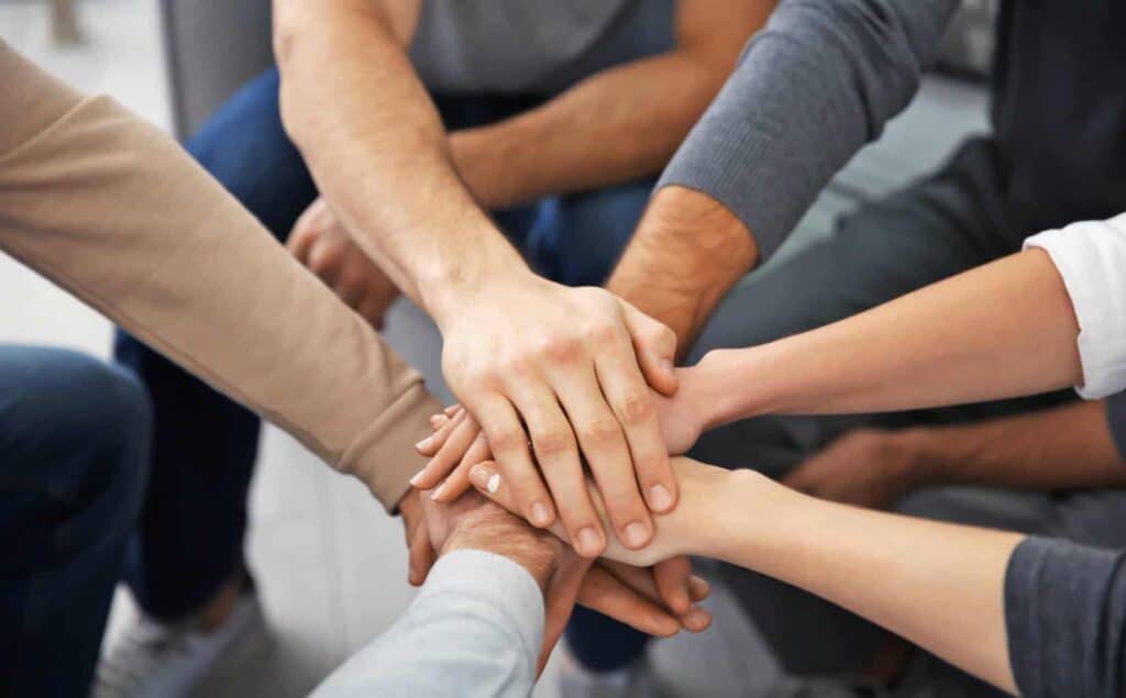 People in a circle offering mutual support during benzo addiction treatment in Massachusetts.