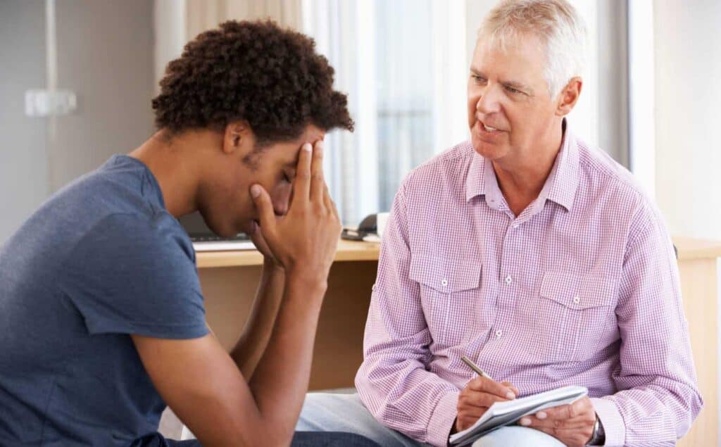 Man participating in a one-on-one therapy session for meth addiction treatment in Massachusetts.