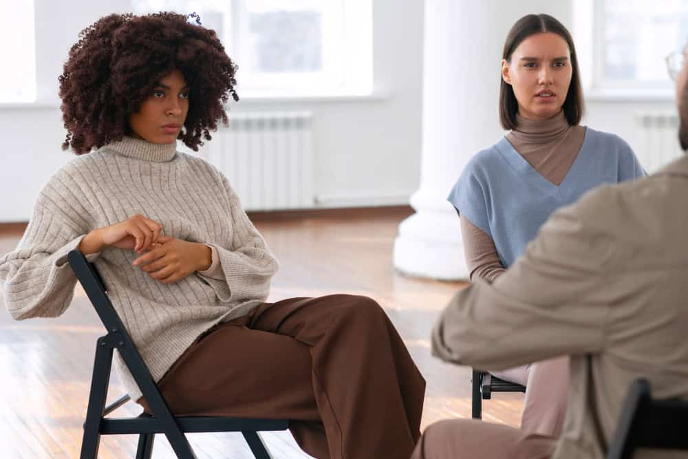 People sharing feelings and emotions during group therapy session