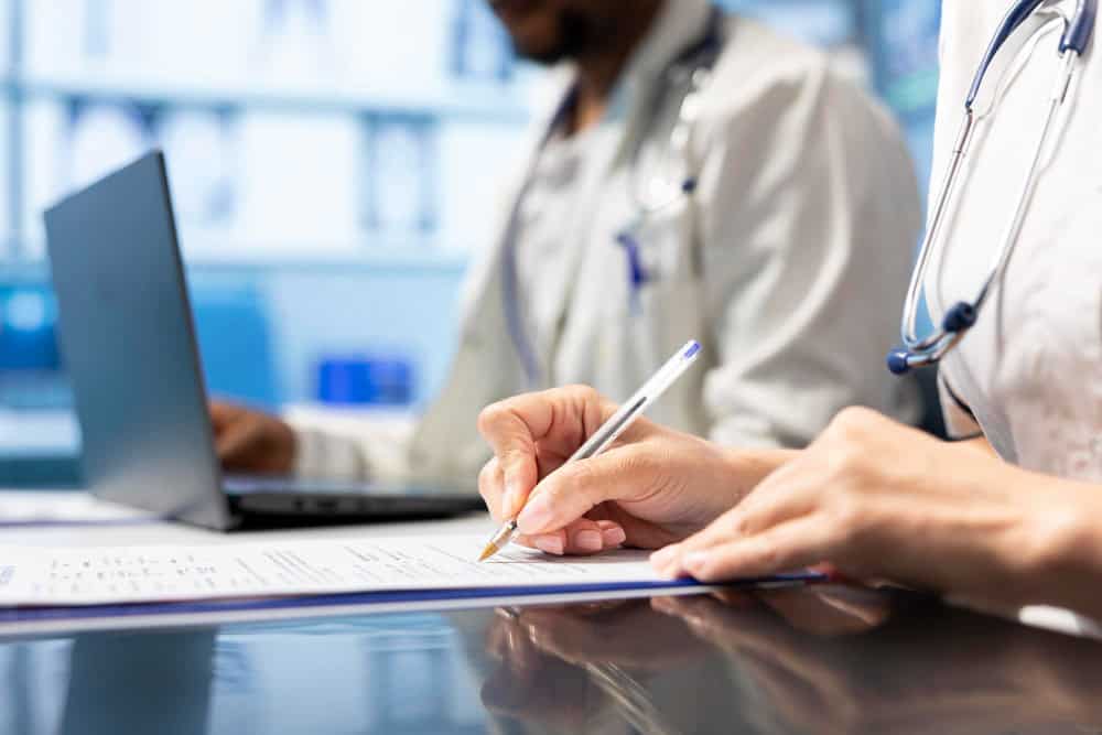 Physician writing a prescription treatment plan to help with recovery