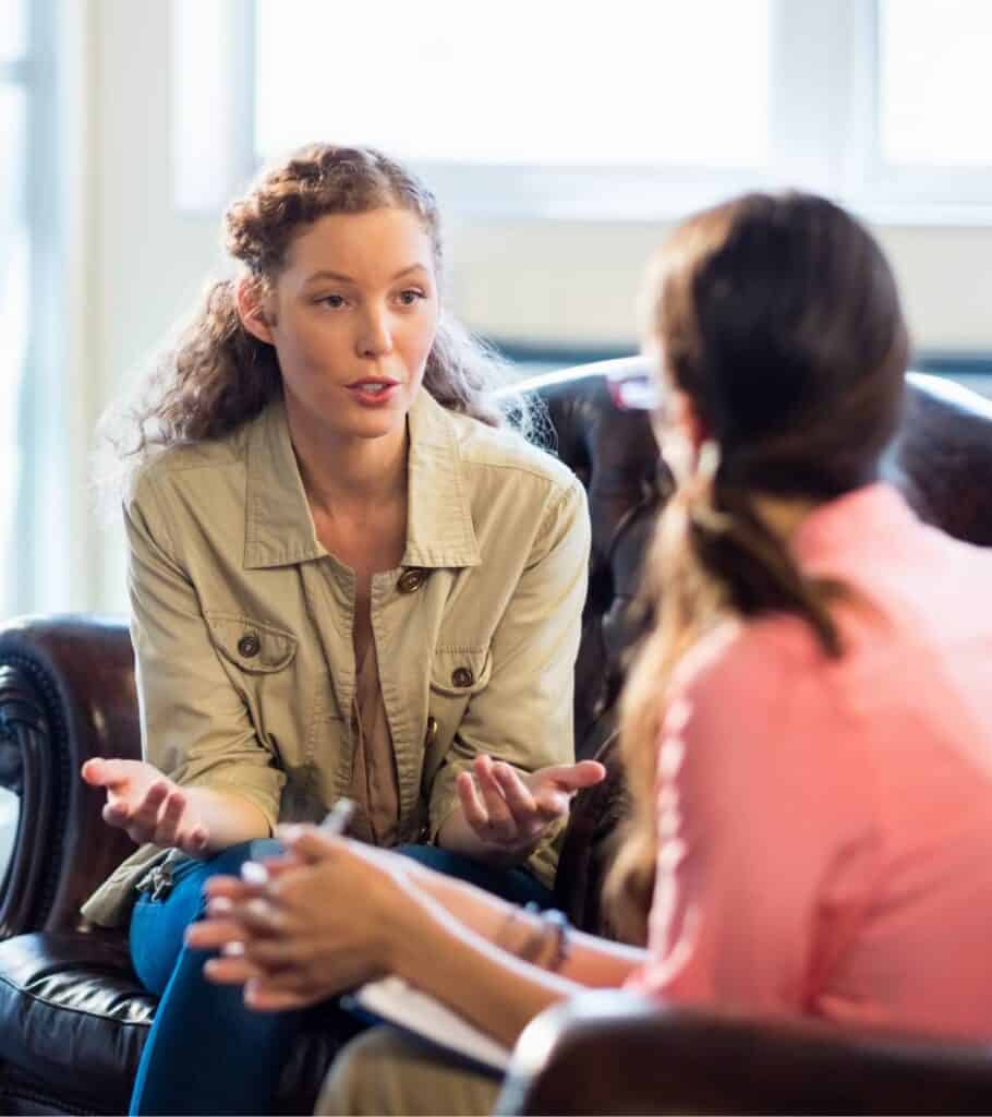Woman discussing meth addiction symptoms with clinician.