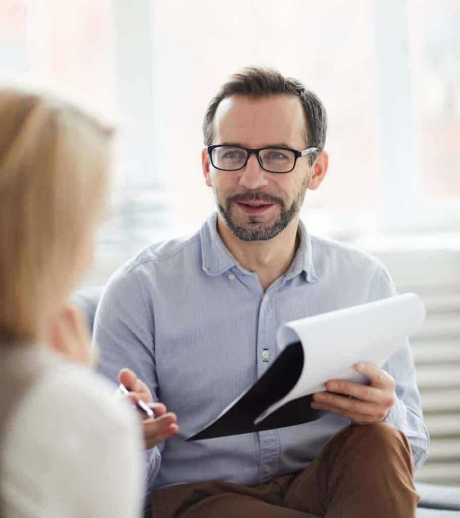Therapist offering steady support to a client during a session.