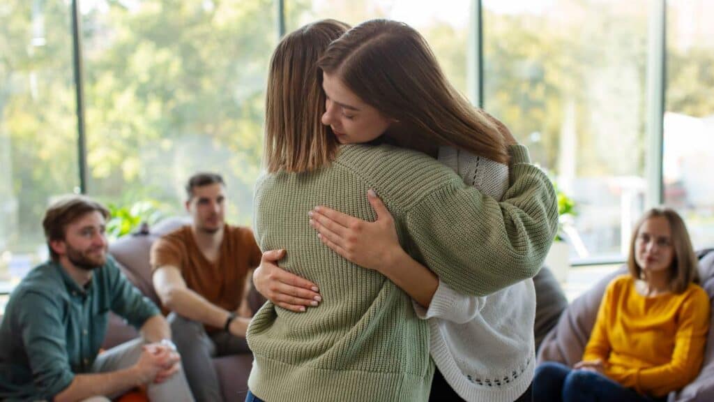 Group of patients in a meeting room for MDMA addiction treatment in Hanover.