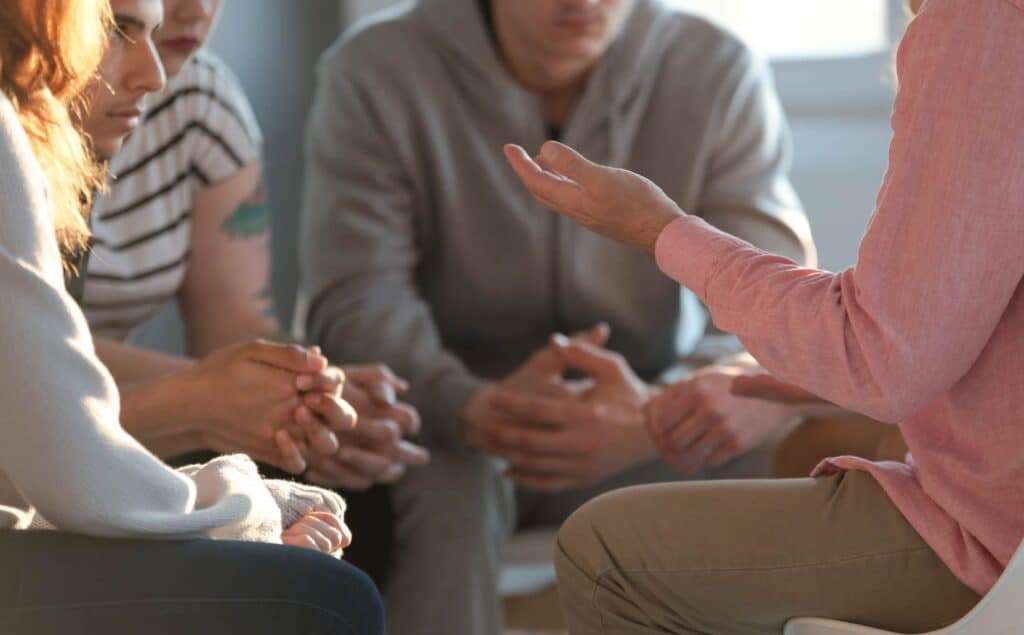 Residents gathered for a group meeting in sober living in Hanover.