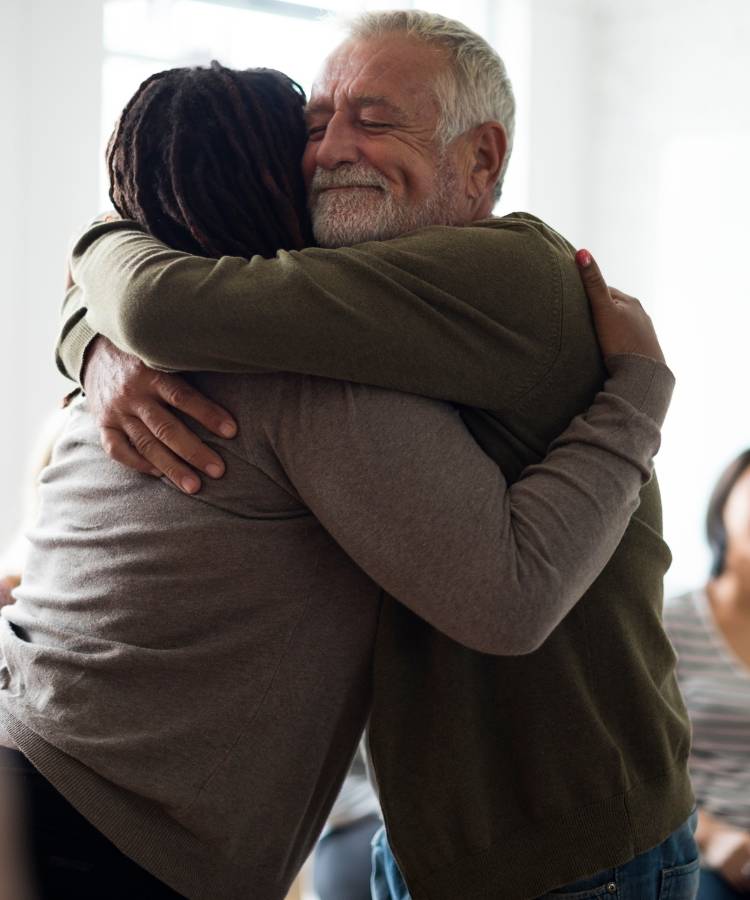 Man sharing a hug with a family member in sober living in Hanover.