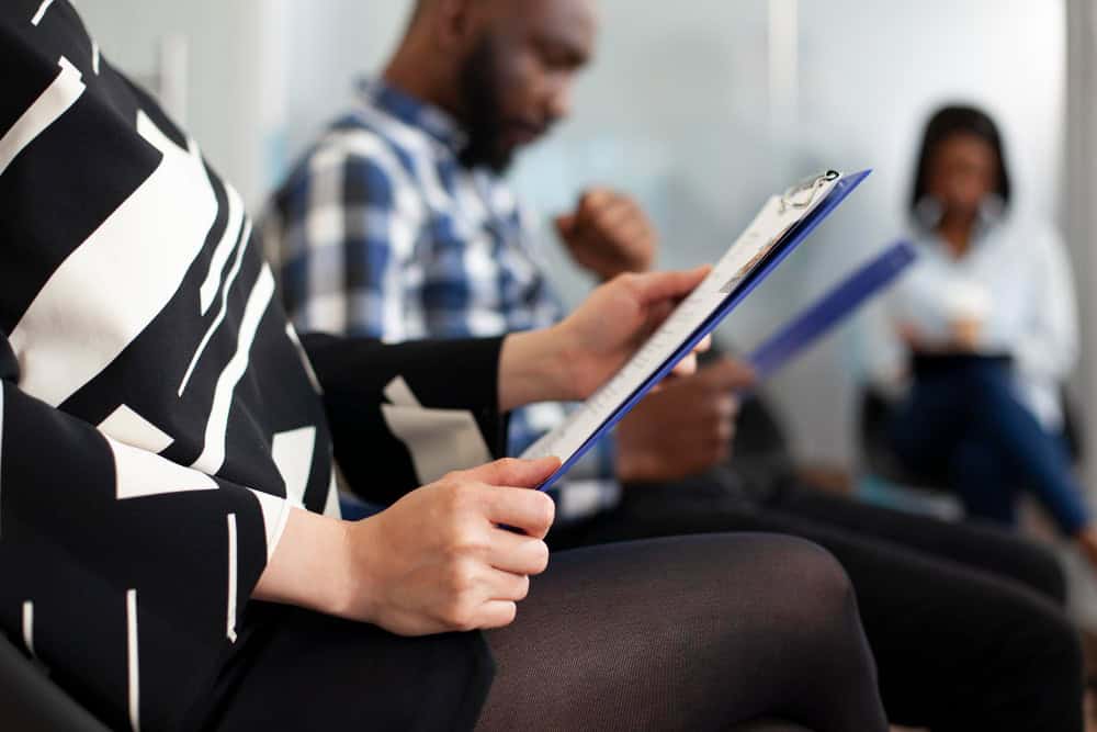 Woman holding a notebook while preparing for a psychiatry appointment in Boston, MA at Brook Addiction Treatment Center.