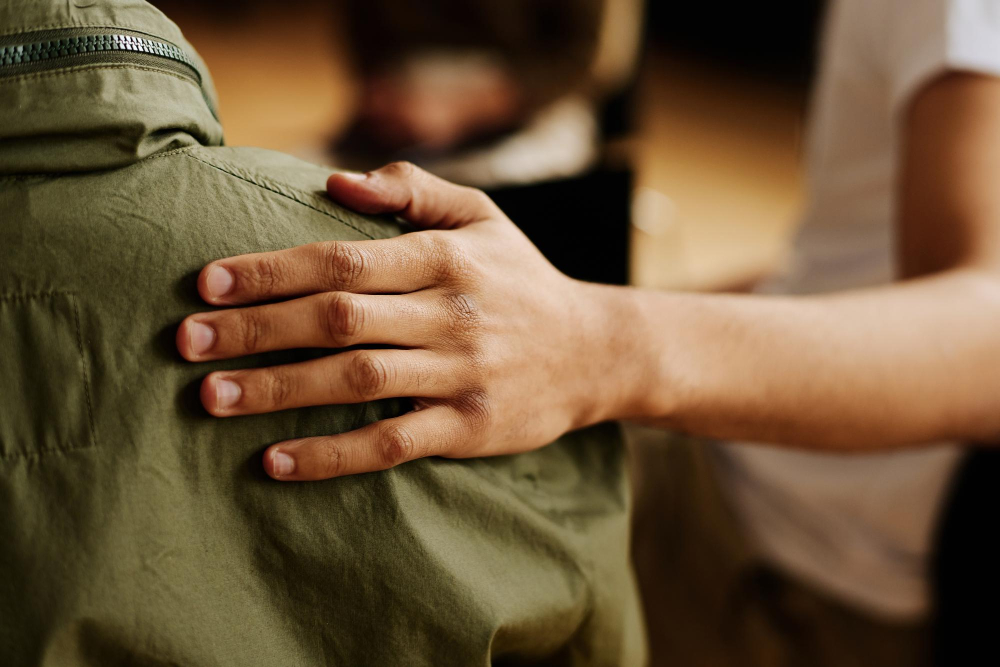 Young person comforting a friend, demonstrating how to support someone in rehab.