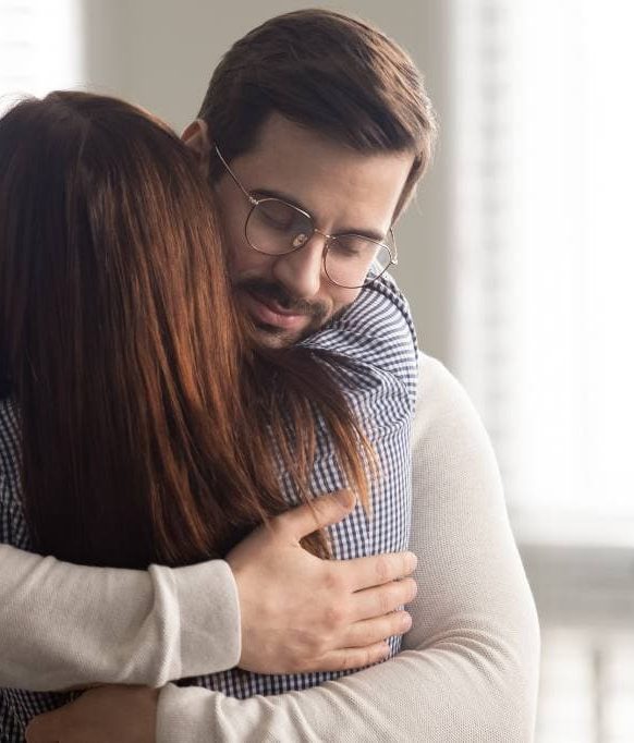 Man sharing a supportive hug with a loved one at drug rehab in Hanover, MA.