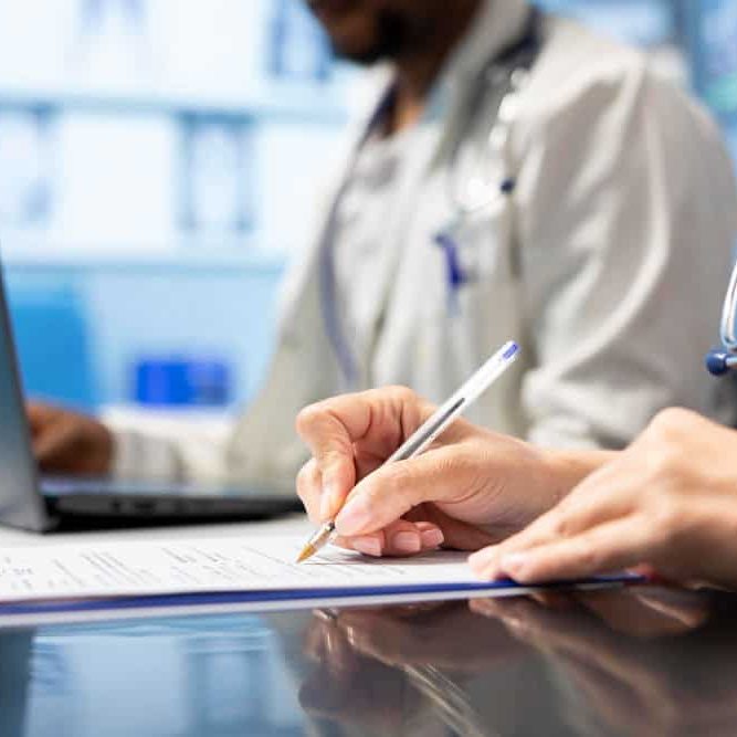 Physician writing a prescription treatment plan to help with recovery