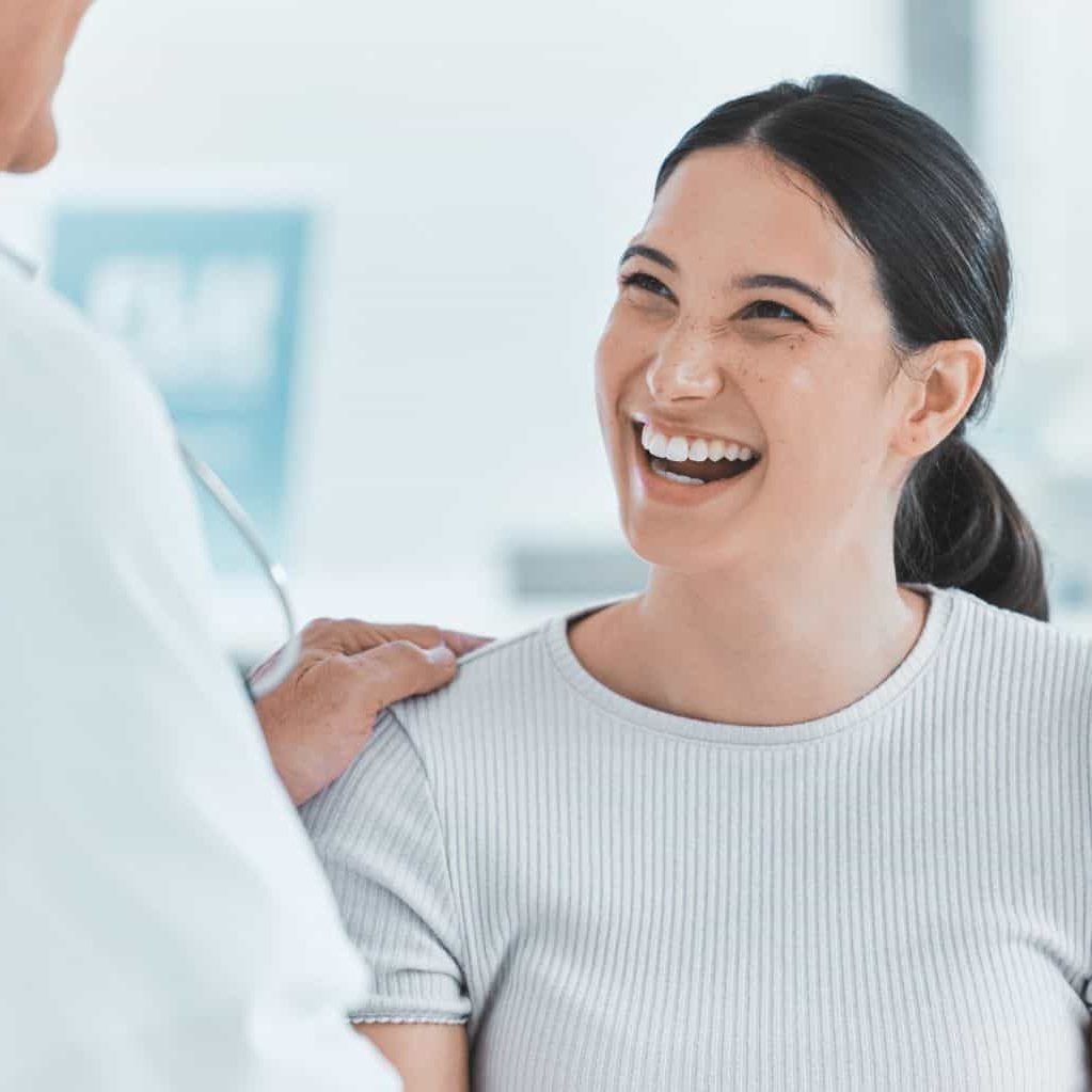 Woman smiling in a clinic setting for detox in Hanover, MA.