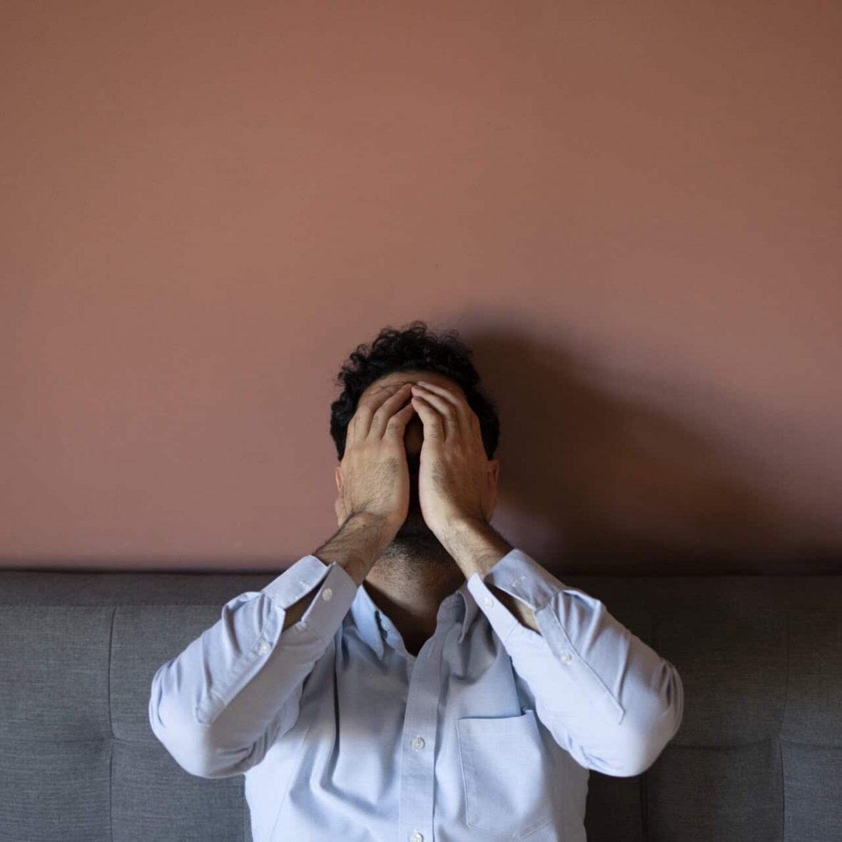 frustrated-man-couch-front-view