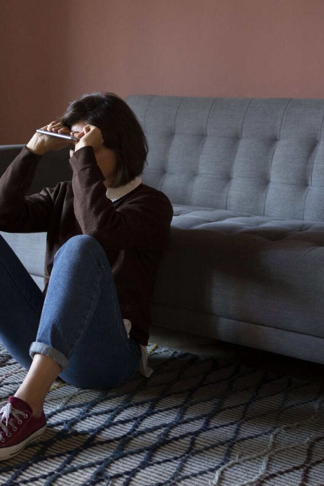 full-shot-anxious-woman-sitting-floor