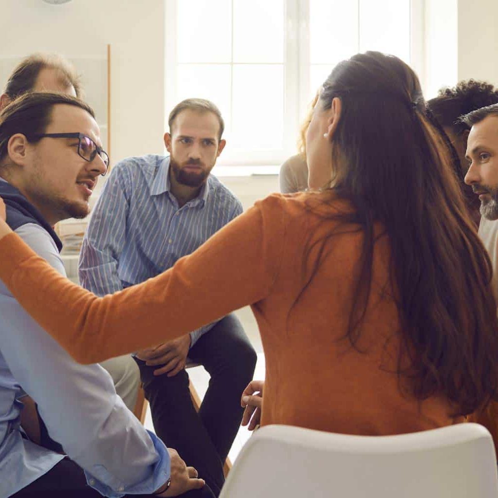 Clients participating in group therapy during opioid addiction treatment in Hanover.